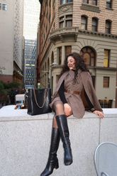 a lady in a coffee brown cloak, a vest and a pair of brown wool shorts